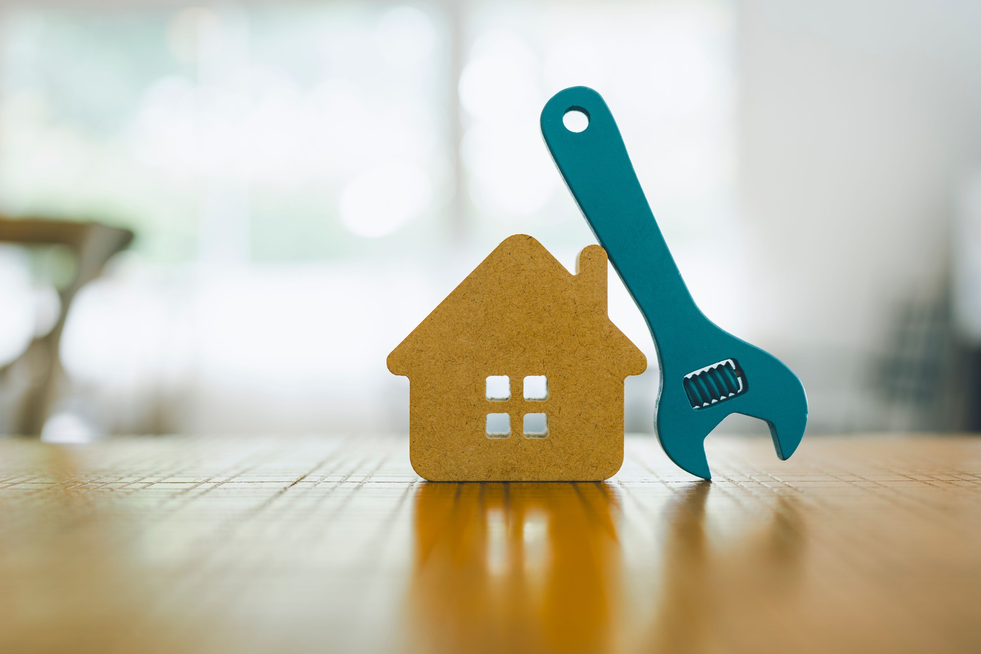Model house and wrench, home services. Home repairs concept.
